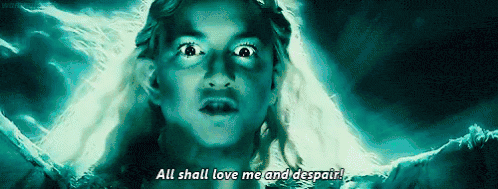 Galadriel from "The Lord of the Rings" is lit by blue light, her hair blowing in the wind and her eyes unnaturally bright, as she declares "All shall love me and despair!"