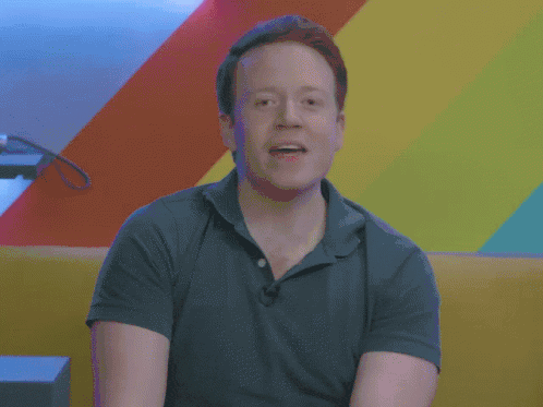 Brennan Lee Mulligan wearing a green, unbuttoned polo shakes his head as he says, "At this point, do I even need to say 'get in the comments?'"